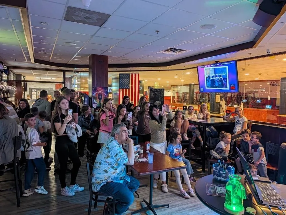 Guests watching and joining a karaoke show at Coach’s Corner